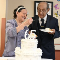 65th Wedding Anniversary. Couple eating cake.